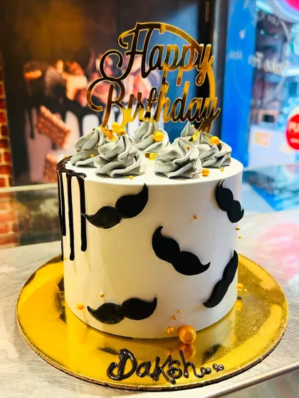 A fun and simple "little man" themed cake with a mustache pattern, perfect for a boy's birthday or a dad.