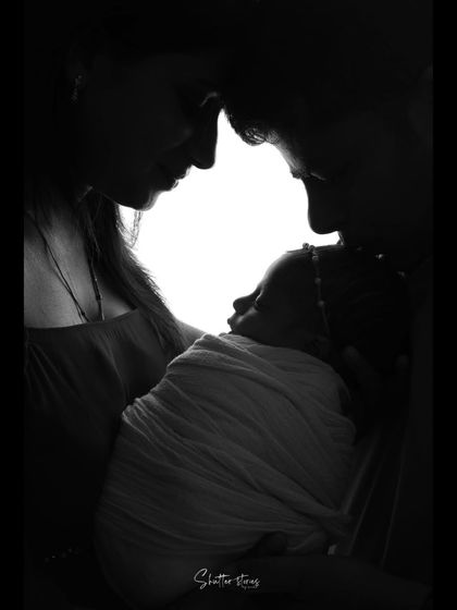 Another powerful silhouette, this one capturing the parents' foreheads touching as they gaze at their newborn.