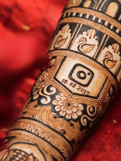 A detailed close-up of the Instagram logo and date from a different bride's mehendi. This shows how popular and meaningful such modern symbols can be.