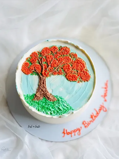 This cake is a tribute to the beautiful Gulmohar tree. The design is hand-piped with colored buttercream to create a miniature painting you can eat.