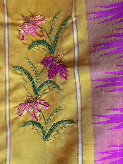 Another detail of the custom Kamal Kadai work, showing the delicate floral vine. I carefully select thread colors to complement the saree's base, ensuring the embroidery enhances the beauty of the original textile.