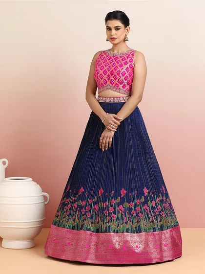 This angle highlights the intricate pleating of the silk skirt and the delicate embroidery on the blouse.