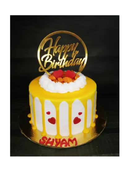 Back to basics with this fresh mango drip cake. The simple design with bright yellow and red heart accents makes it a cheerful birthday treat.