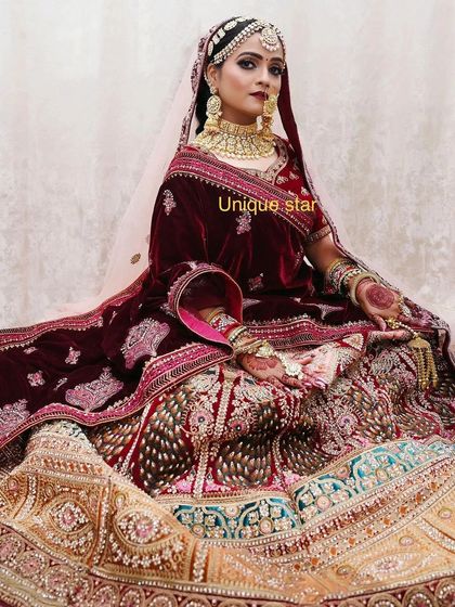 For brides who want a truly regal look, I offer heavily embroidered velvet lehengas with matching jewellery sets. This maroon lehenga is paired with a gold-plated choker and jhumkas, available for rent.
