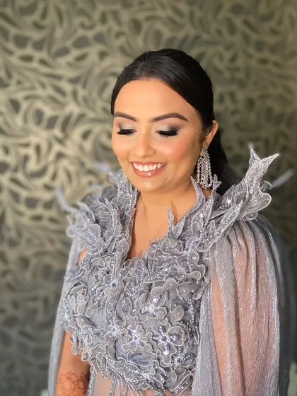 When the bride's smile lights up the room. Bansi's reception look in this unique grey gown was all about smokey eyes and pure confidence.