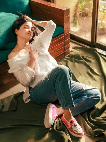 A full-body shot showing a casual, laid-back style. The pop of color from the shoes adds a fun detail to this lifestyle portrait.