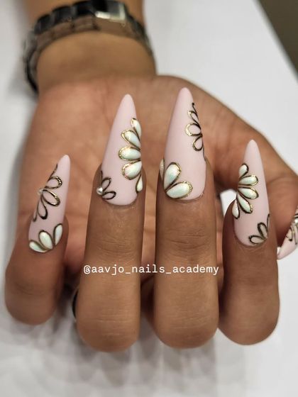 This angle shows the full set of the matte pink and chrome floral nails. It's a perfect blend of modern trends and classic artistry.