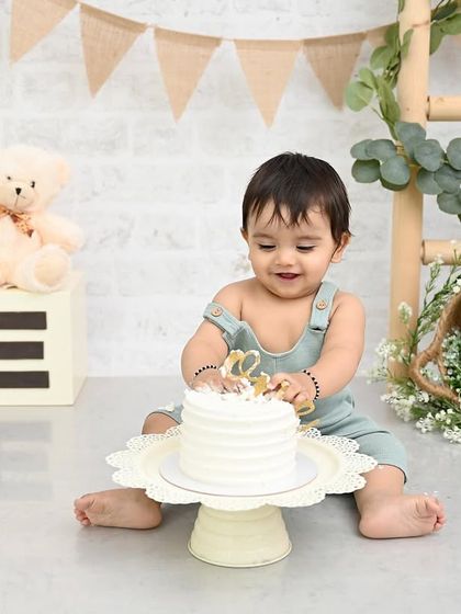 The first curious touch. This is the moment before the smashing begins, full of anticipation and wonder. This rustic-themed cake smash for a baby boy is simple, sweet, and absolutely adorable.