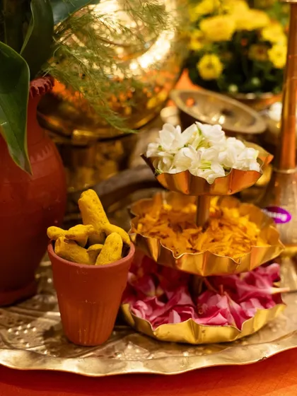 A display of traditional Indian elements, including whole turmeric and fresh flowers. We believe in honouring the roots of our cuisine in every aspect of our presentation.