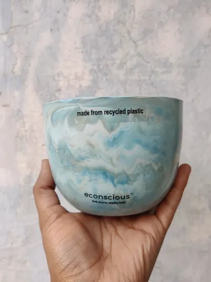 This planter features a stunning ocean-like swirl of blue and white. It shows how recycled plastic can be transformed into something truly artistic and beautiful for your home decor.