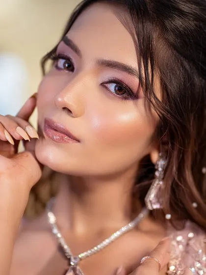 A close-up of the dramatic eye makeup. The blend of purple and pink shadows creates a look that is both bold and beautiful.