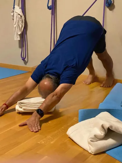 A demonstration of Adho Mukha Svanasana (Downward-Facing Dog) for an online class, focusing on lengthening the spine and opening the shoulders.