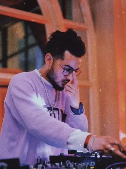 A focused shot of me at the decks, deep in thought while selecting the next track. Curating the right musical journey for the crowd is a craft I take seriously.