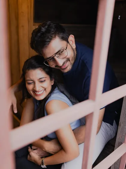 Peeking through a window to capture a burst of genuine laughter. I love using frames within the environment to create a sense of a private, stolen moment of joy.