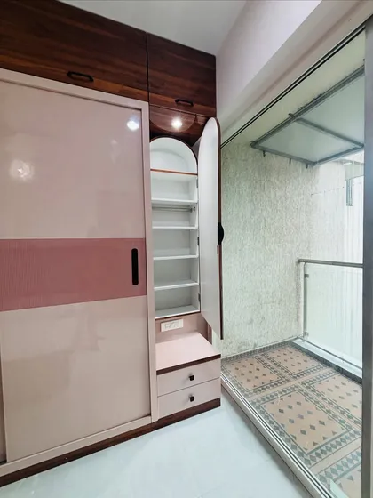 This shows a hidden feature of the sliding wardrobe: a slim, pull-out cabinet with shelves, perfect for storing accessories, cosmetics, or shoes.