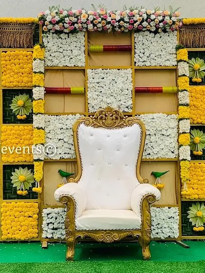 This vibrant checkerboard backdrop is one of our most requested designs. We use fresh marigolds, chrysanthemums, and woven palm leaves to create a bright and auspicious setting perfect for any celebration.