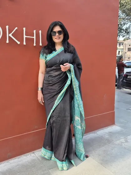 A beautiful cotton silk saree is a wardrobe essential. The contrast of the teal palla against the black makes this piece stand out. I help clients source unique sarees and show them how to style them for a modern, elegant look.