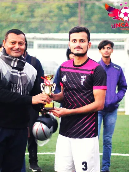 A player from the runner-up team receives his trophy. I believe in recognizing the effort of all top performers, not just the final winners.
