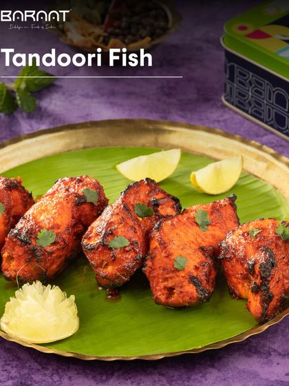 Our Tandoori Fish, served on a banana leaf with lemon wedges, is a testament to the simple perfection of tandoori cooking.
