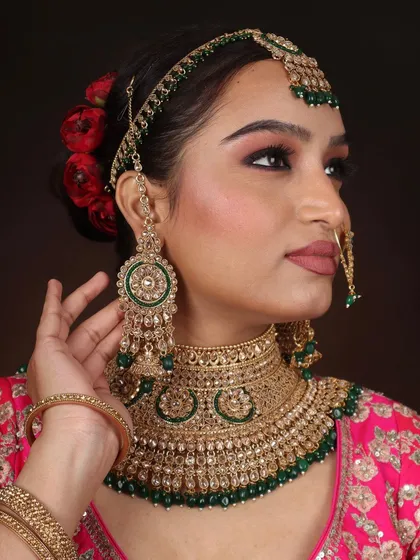 A close-up of the intricate details. This shot highlights the blended eyeshadow, the sharp winged liner, and the traditional jewellery that completes this North Indian bridal look.