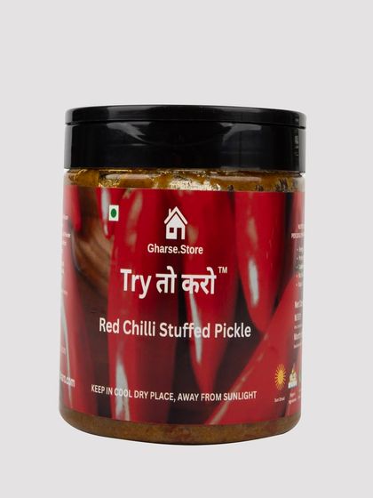 A jar of Red Chilli Stuffed Pickle on a white background.