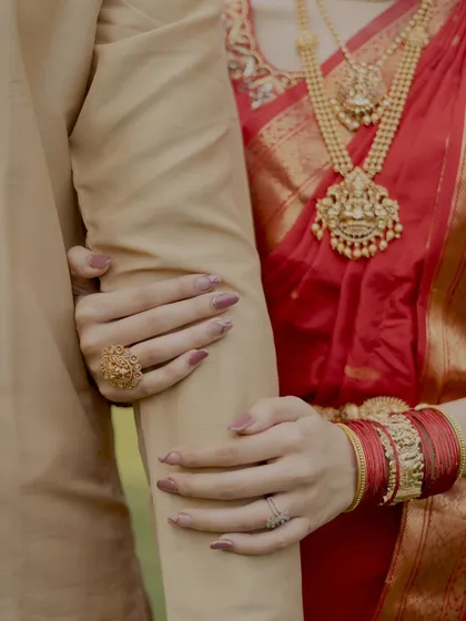 It's all in the details. This close up shot focuses on the bride's hands holding the groom's arm, a simple yet powerful symbol of their bond.
