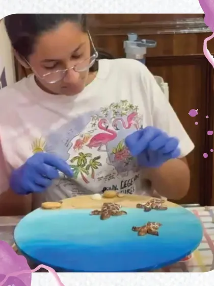 A close-up of a student creating a beautiful turtle-themed resin art piece. This workshop teaches kids how to safely work with resin, mix pigments, and create stunning, glossy ocean scapes.
