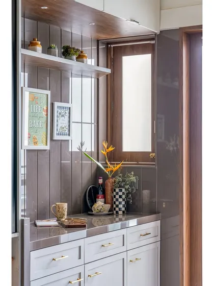 This utility and storage counter shows our focus on practical design. The combination of open shelves and closed cabinets, along with decorative elements, makes the space both useful and beautiful.