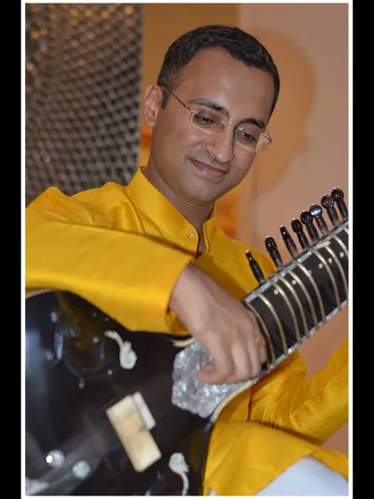 A close-up in a vibrant yellow kurta, capturing a happy moment.