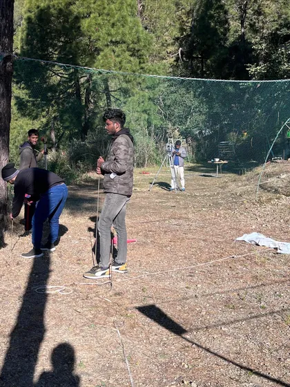 The very first step of any project is understanding the site. Here, my team is on the ground in a pine forest, meticulously surveying and marking out the land to ensure the future structure aligns perfectly with the terrain and existing trees.