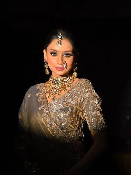 A statement in simplicity and style. This grey-toned saree look is incredibly elegant, with smokey eyes and a classic bun.