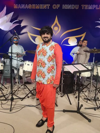 My traditional look for a Navratri performance at the Hindu Temple in Muscat. I love how the outfit complements the grand drum setup of the band behind me.