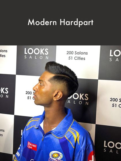 Inspired by the sharp looks on the cricket field, this Modern Hardpart haircut features a clean, defined part and a skin fade. It's a bold, athletic style that's perfect for making a statement.