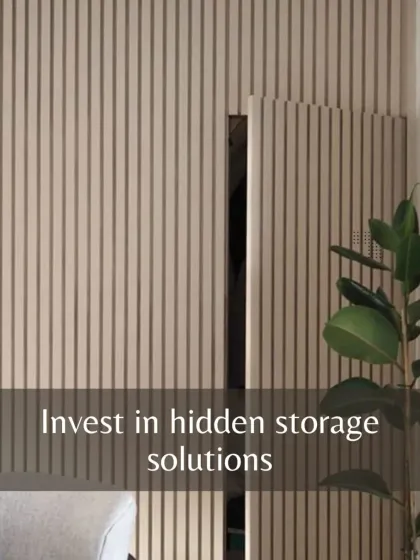 Invest in hidden storage solutions. This fluted wall panel cleverly conceals a door, creating a seamless and clutter-free look while providing access to another space.