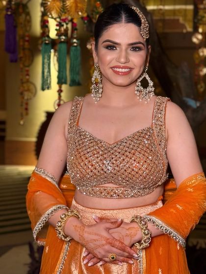 A beautiful, happy client ready for a Sufi night. I gave her a glowing look with a pop of orange and a creative, modern braid.