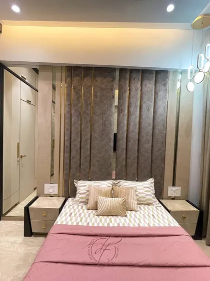 A closer look at the bed and the detailed headboard with metallic accents. The modern pendant light adds a touch of elegance and provides warm, ambient lighting.