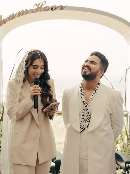 The groom looks up at his bride with pure adoration as she reads her vows. His joyful, uninhibited laughter is a perfect, candid expression of his love.