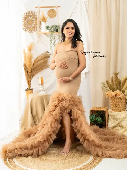 A full-length view of the stunning ruffled gown, showing how it spreads out beautifully on the jute rug in our studio.