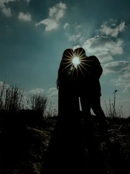 A powerful silhouette of a couple sharing a kiss, perfectly timed with a sunburst effect. This artistic shot showcases our skill in using natural light to create dramatic and memorable pre-wedding images.