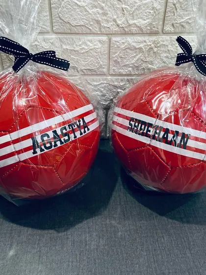 Two personalised footballs, wrapped and ready to be gifted. These make for fantastic and unique birthday return favours for a sports themed party.