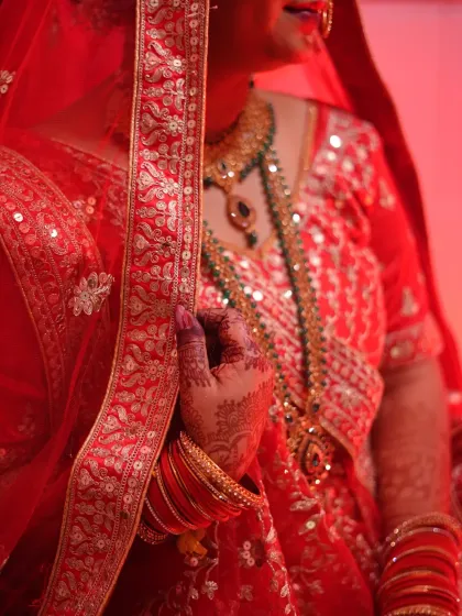 A close-up shot focusing on the bride's henna, bangles, and the rich fabric of her lehenga. These detail-oriented photos are essential for telling the complete story.
