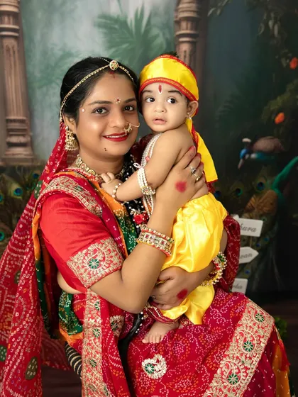 A mother and her baby, dressed as Yashoda and Krishna, share a beautiful moment during our Janmashtami special photoshoot.