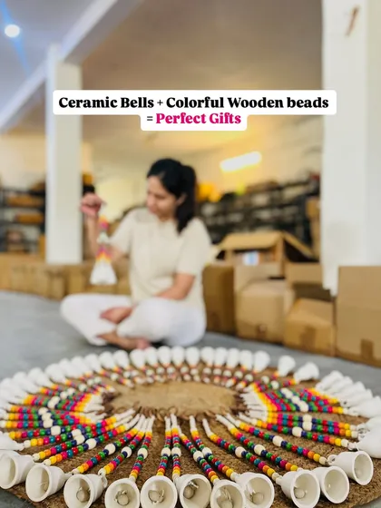 Our 'Rainbow Bells' are going places. This image shows a beautiful arrangement of our mini ceramic bells with vibrant wooden beads, ready to be packed. They are one of our cutest decor pieces and a perfect gift option.