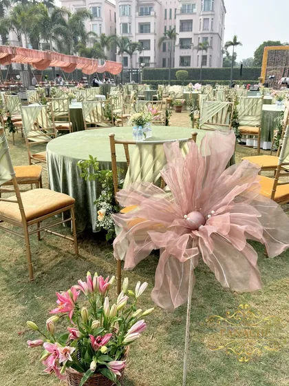 Another view of the guest seating, showing the giant organza flowers and floral arrangements in baskets.