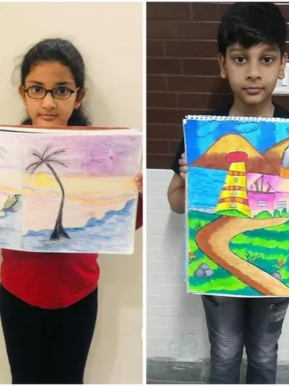 These students show their impressive landscape drawings. One captures a serene sunset over the water, while the other created a bright and cheerful lighthouse scene.