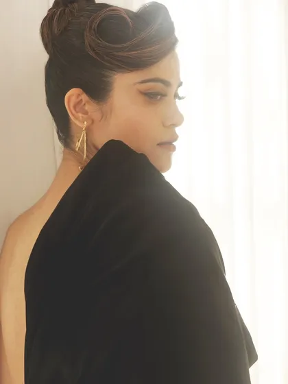 A dramatic backless pose from Aaditi Pohankar. The makeup is kept glamorous with a winged eyeliner and a sophisticated updo to complement the elegant dress.