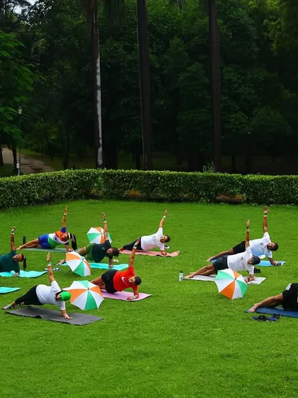 A wider view of our group holding the side plank pose. The synchronization shows the focus and dedication of the entire fit fam.