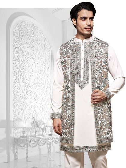 An artistic composition of our craftsmanship. This white kurta is layered with a heavily embroidered open jacket, showcasing a blend of traditional motifs and modern styling.