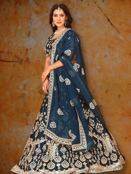 This deep teal lehenga with heavy silver embroidery is perfect for a Sangeet night. The rich color and sparkling details will ensure you stand out.