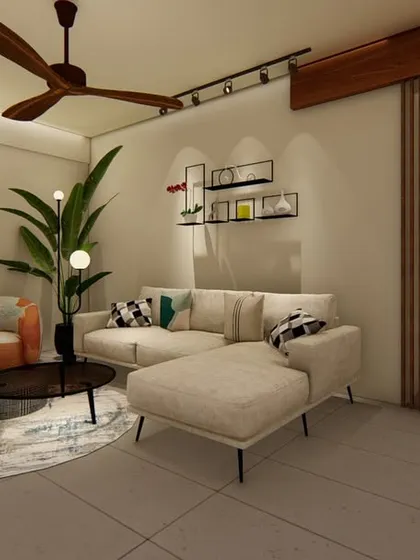 An example of our minimalist living room design, featuring a neutral-toned L-shaped sofa, a simple coffee table, and an accent armchair. The space is defined by clean lines, exposed brick, and a slatted wood partition.